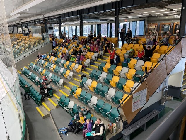 A group of people in a stadium
Description automatically generated