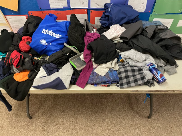 A table full of clothes
Description automatically generated