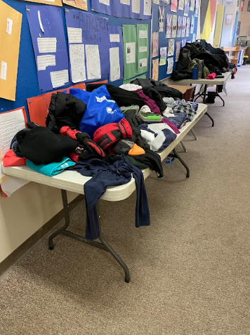 A group of tables with clothes on them
Description automatically generated