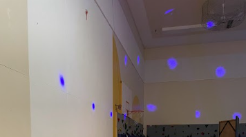 A room with blue spots on the wall
Description automatically generated