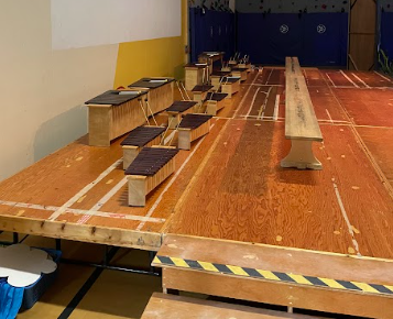 A wooden table with benches on it
Description automatically generated