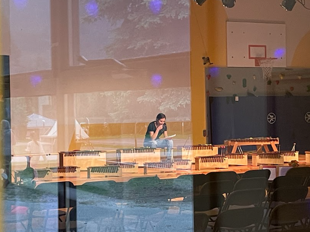 A person sitting on a table
Description automatically generated